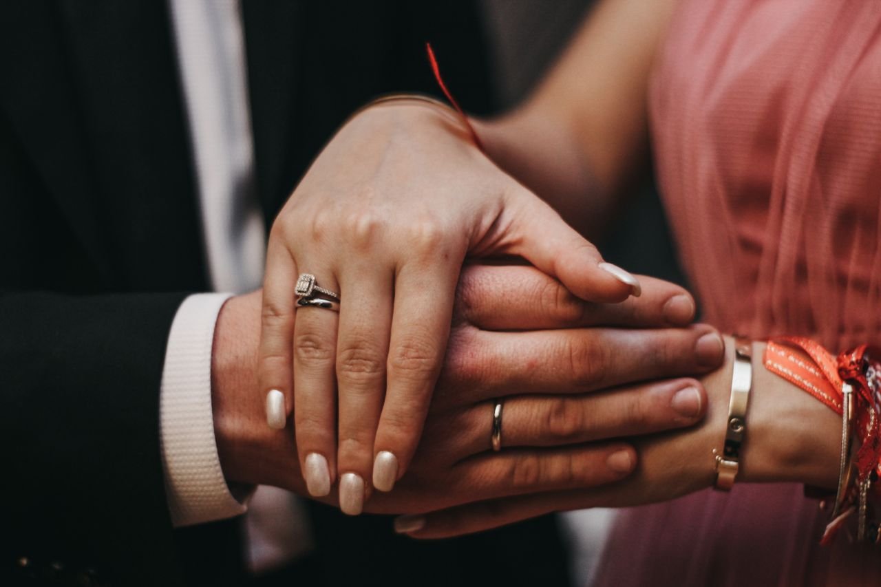 Anniversary gift ideas, hands of a newlywed couple.
