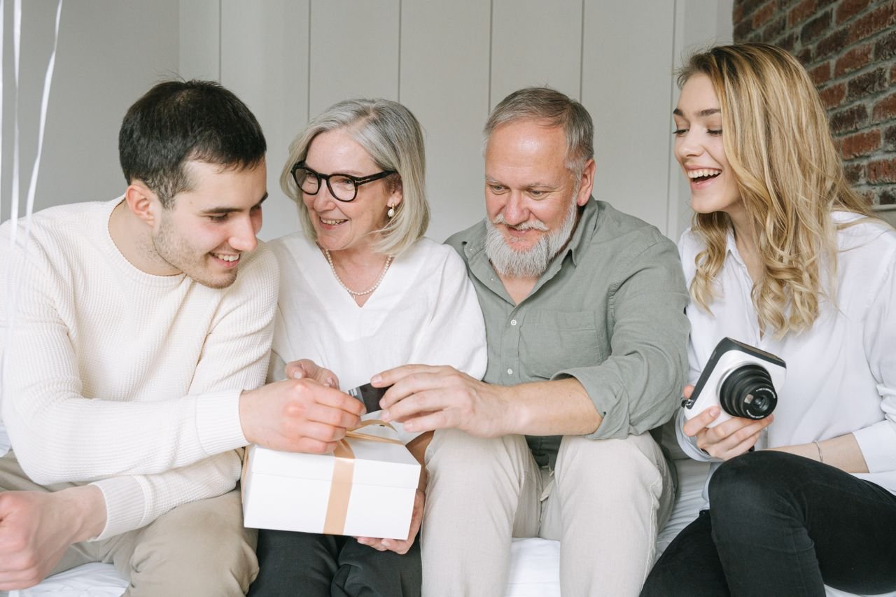 Family exchanging thoughtful gifts for parents at home.